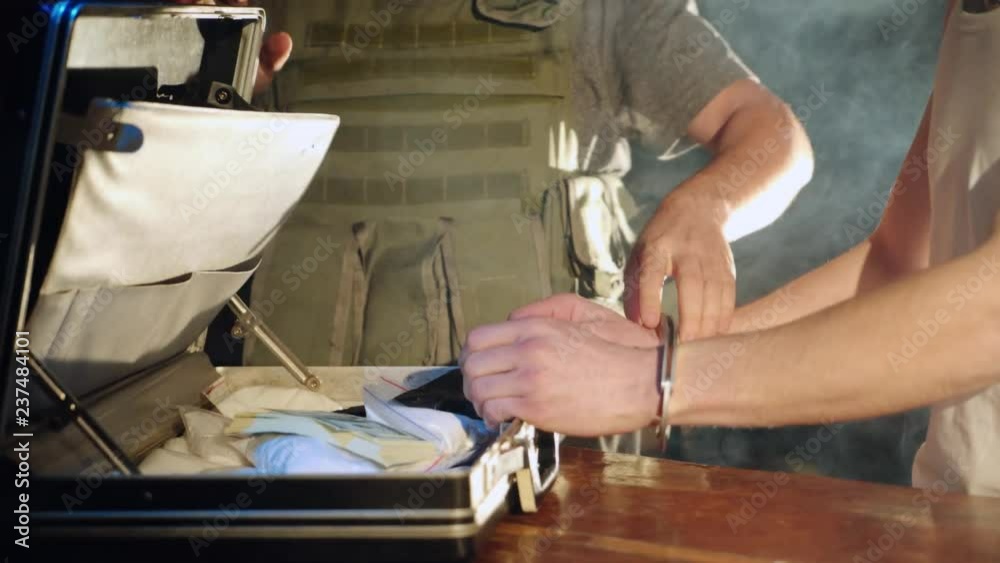 policeman are putting handcuffs on a drug dealer. Criminal in handcuffs