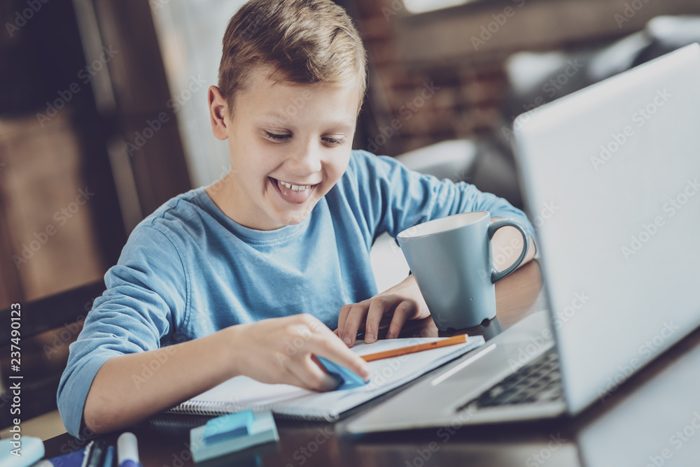 Positive delighted kid using highlighter in task Positive delighted kid using highlighter in task
