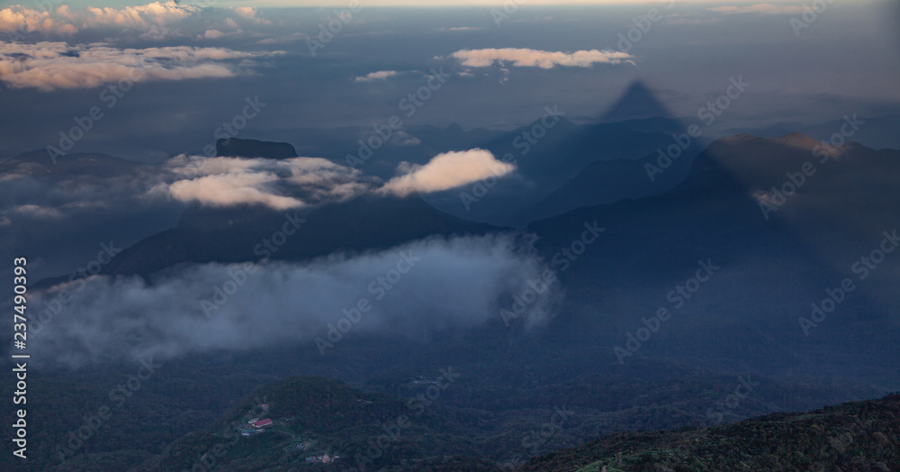 shadow of the conical mountain Adam's Peak or Sri Pada at sunrise - sacred buddhist place. Sri Lanka