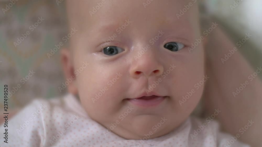 Close up shot of an adorable and happy and smiling newborn baby girl Close up shot of an adorable and happy and smiling newborn baby girl