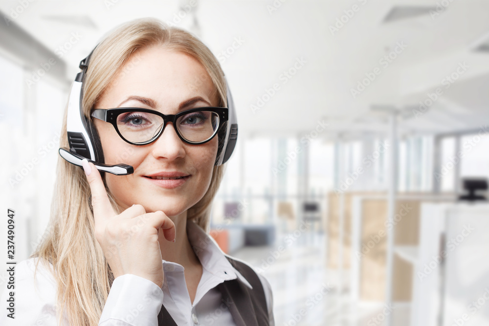 Three call center service operators at work. Portrait of smiling pretty female helpdesk employee with headset at workplace. Three call center service operators at work. Portrait of smiling pretty female helpdesk employee with headset at workplace.
