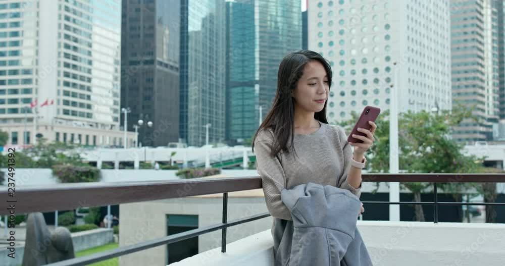Woman use of mobile phone in Hong Kong city Woman use of mobile phone in Hong Kong city