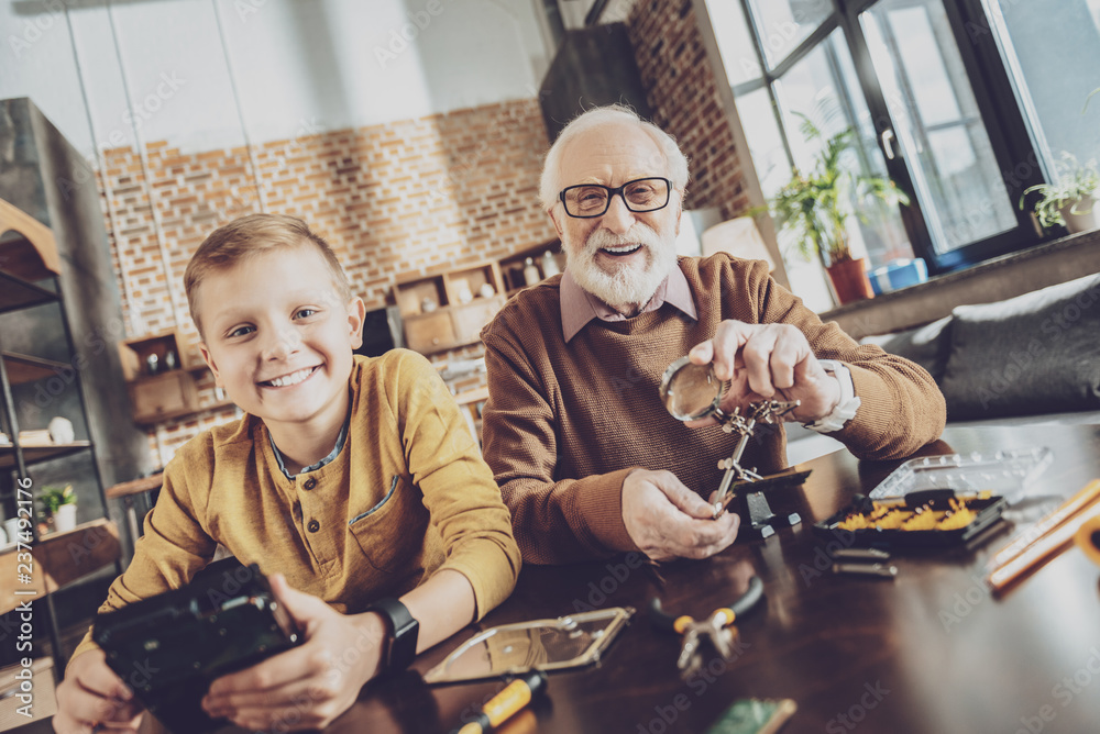 Pleased kid spending weekends with grandfather