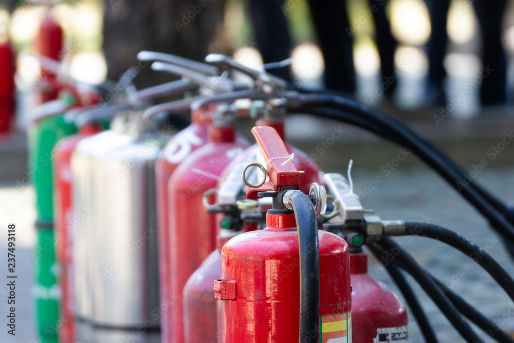 Close up Fire Safety Set Different Types of Extinguishers Placed outdoors for staff training.