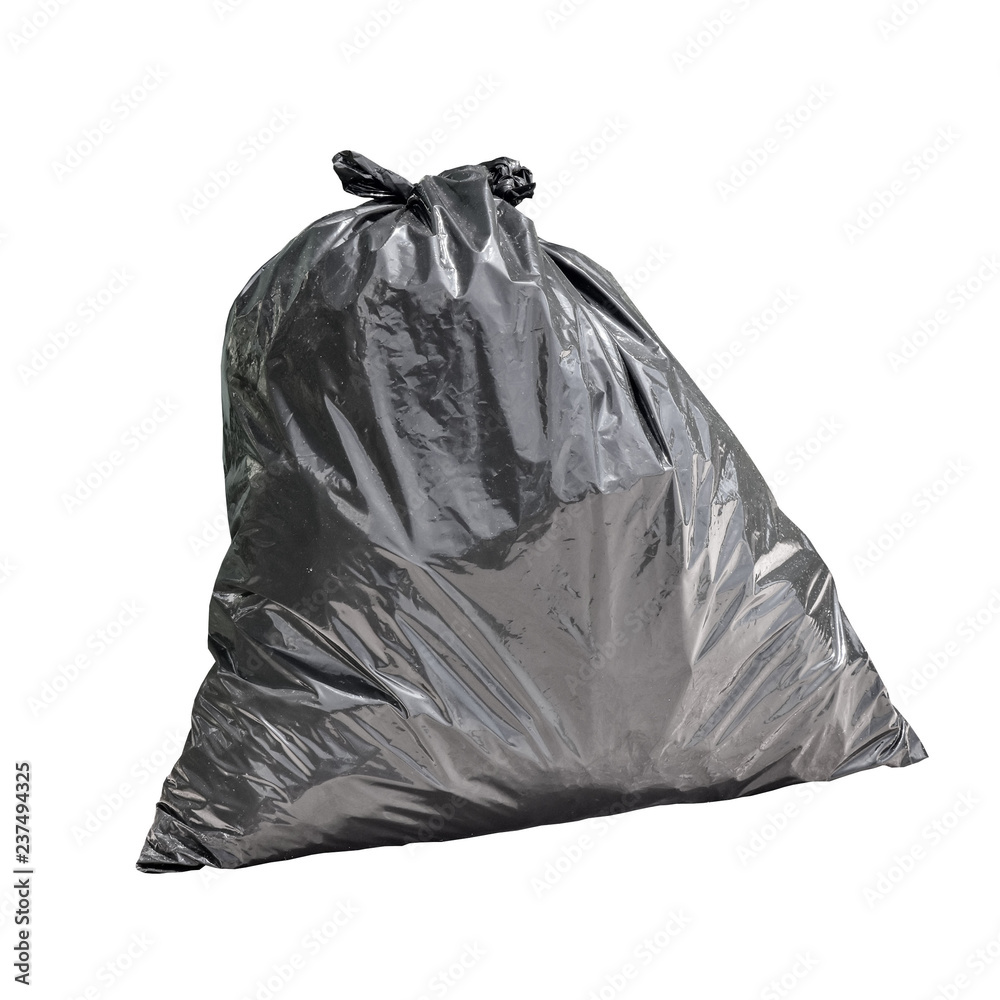 Black garbage bag next to green fence Black garbage bag next to green fence