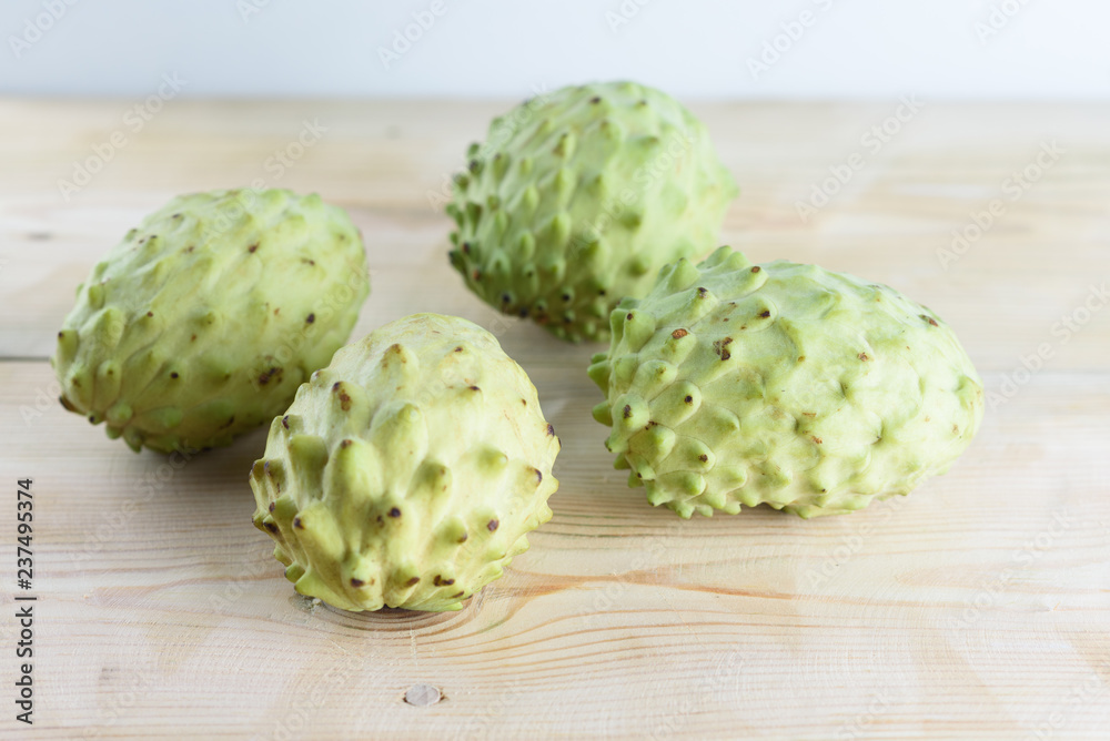 Annona, Custard Apple, Cherimoya, Sugar Apple. Woman Hands Holding Annona Fruit on White Background.