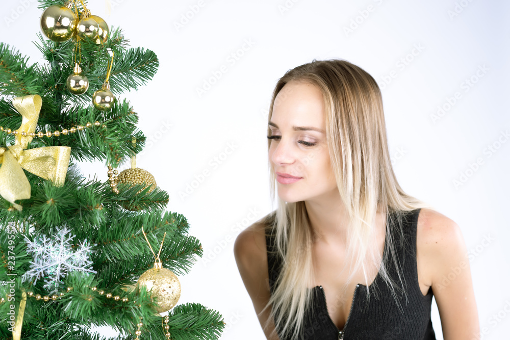 Beautiful girl model celebrates Christmas or New Year in studio