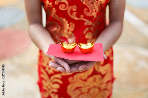 Portrait of a beautiful Asian Woman hold with luck money and red pocket,chinese new year concept.