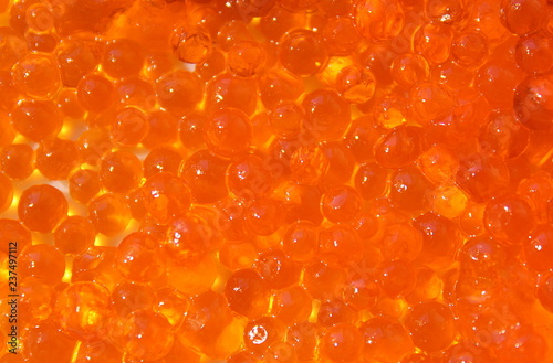 Texture red fish roe spread out in a thin layer