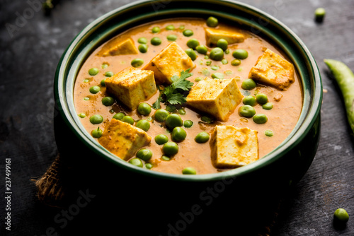 Green peas or matar paneer curry recipe, served in a bowl. selective focus