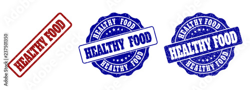 HEALTHY FOOD grunge stamp seals in red and blue colors. Vector HEALTHY FOOD imprints with grunge surface. Graphic elements are rounded rectangles, rosettes, circles and text captions.
