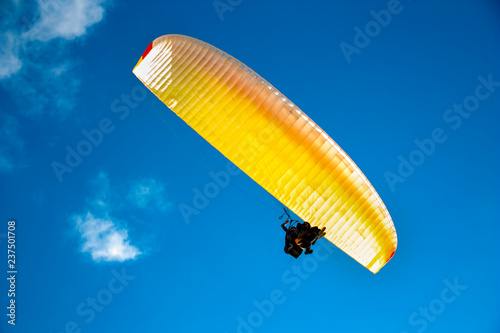 paraglider on the background of bright blue sky
