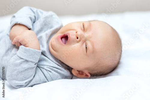 newborn is yawning and wants to sleep