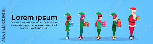 santa claus elf helper team ride electric scooter new year merry christmas concept full length profile horizontal banner copy space