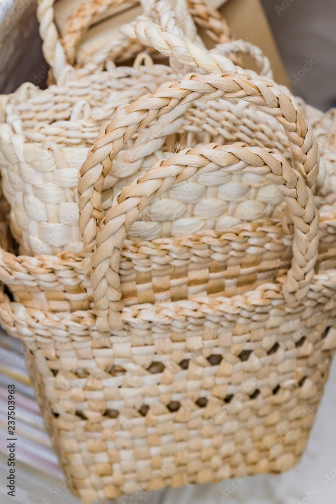 Stack of wicker baskets. Handmade goods for sale. Selective focus.