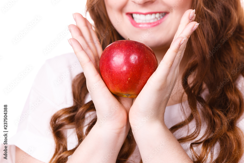 Woman holds apple fruit close to face, isolated Woman holds apple fruit close to face, isolated
