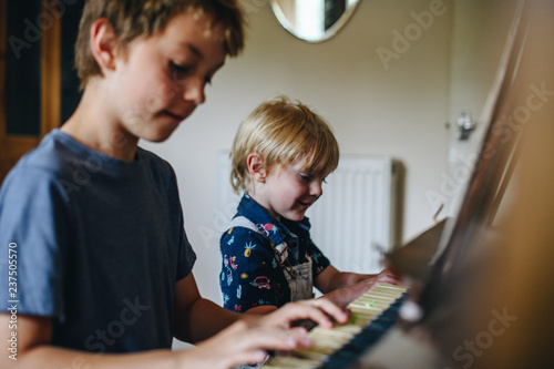 Brothers playing the piano