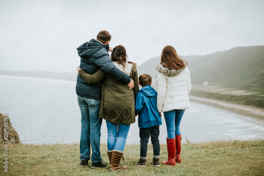 Parents with their children looking at the ocean Parents with their children looking at the ocean