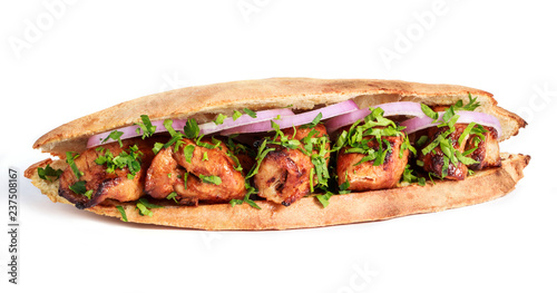 Grilled meat in sandwich with onion and greens on white background. Shashlik or Shish kebab popular in Eastern Europe. Hot meat dishes