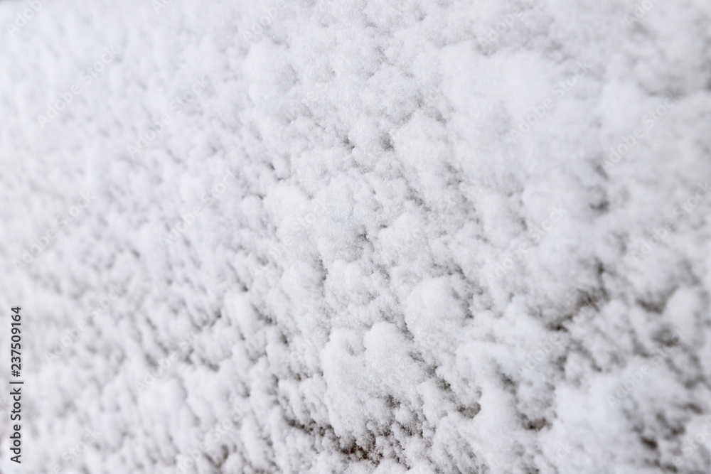Texture of adhering snow on a vertical surface, close-up view, selective focus. Texture of adhering snow on a vertical surface, close-up view, selective focus.