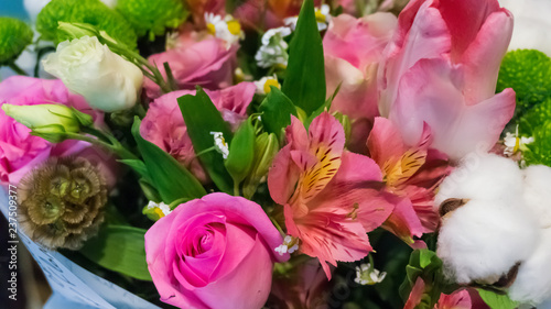 Roses and buds of natural white cotton in a bouquet of flowers