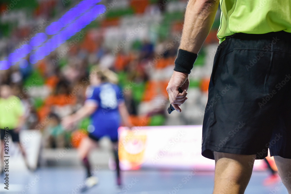 handball referee hand with whistle