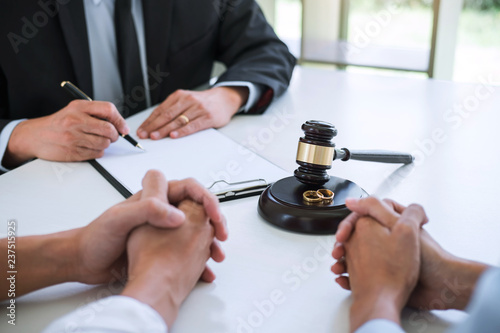 Agreement prepared by lawyer signing decree of divorce (dissolution or cancellation) of marriage, husband and wife during divorce process with male lawyer or counselor and signing of divorce contract