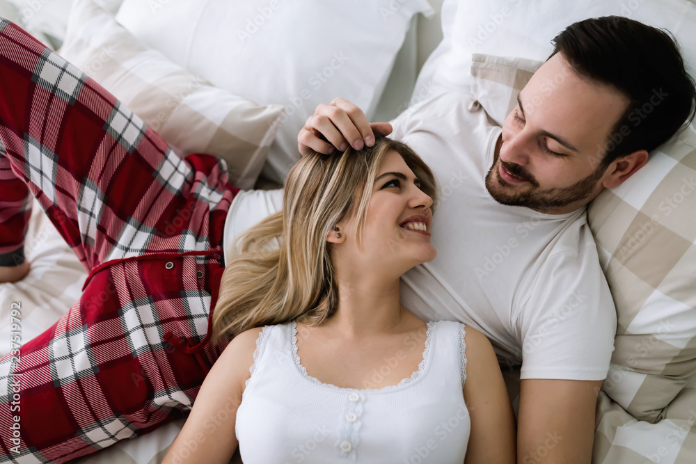 Fototapeta premium Young attractive couple having romantic time in bed