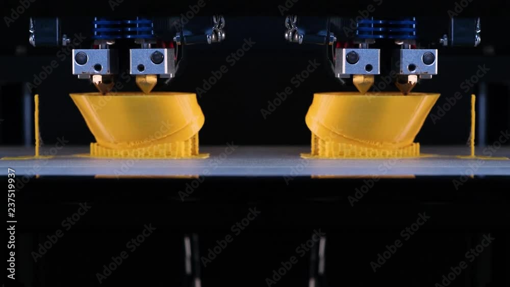 3d printer prints the two model of the hands, process of printing hands prosthesis on the 3d printer. Accelerated video. 4k footage.