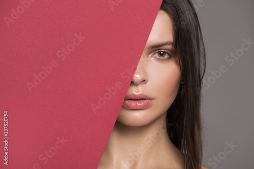 Portrait of a beautiful woman. Fashion makeup Fragment of the face. Gray background.
