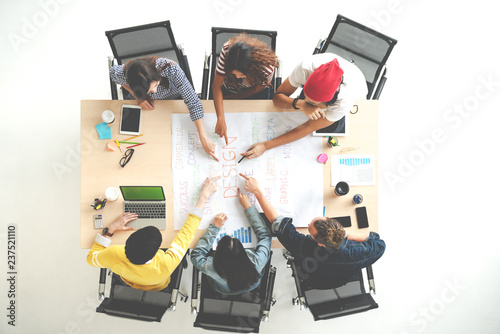 Top view of creative diverse people agree result together. Overhead view of young creative team, start up colleagues group or college student meeting and voting agree opinion by pointing hand at desk.