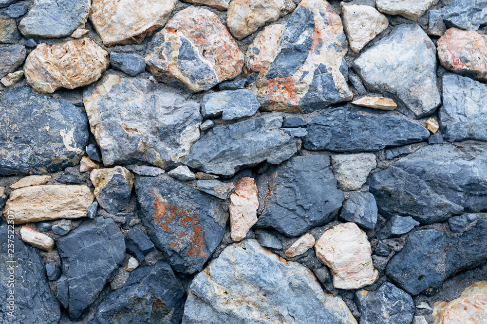 old stone wall of stones of different sizes and colors as a natural background old stone wall of stones of different sizes and colors as a natural background
