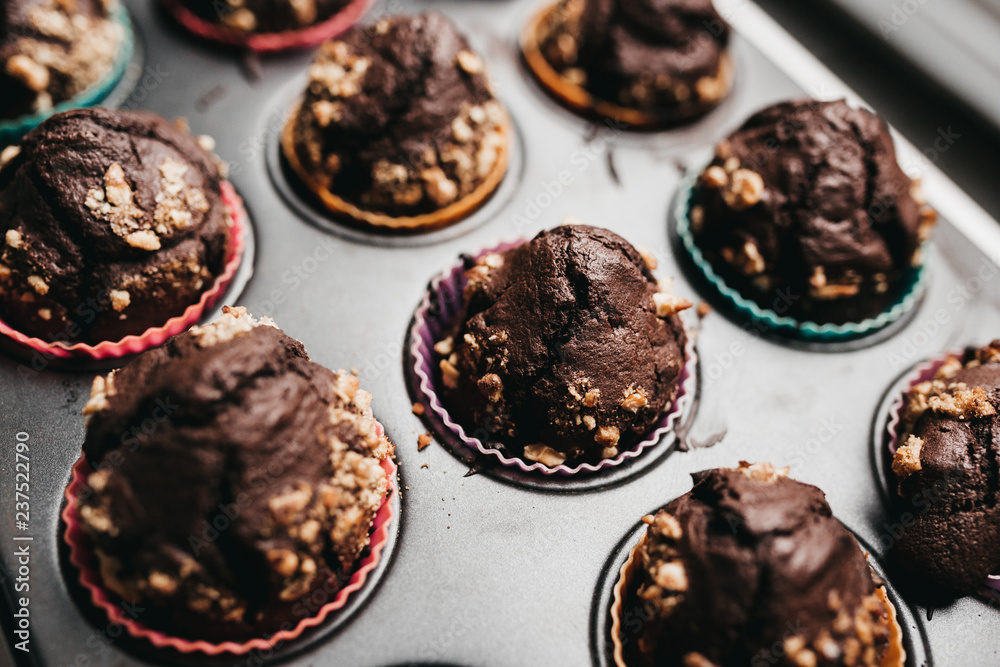 Close up of freshly baked chocolate muffins on muffin pan Close up of freshly baked chocolate muffins on muffin pan