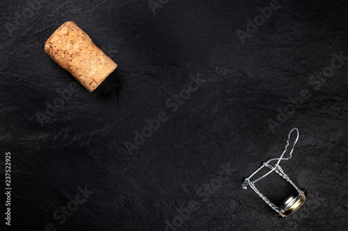 Canvastavla A photo of a champagne cork and closure, shot from the top on a black background