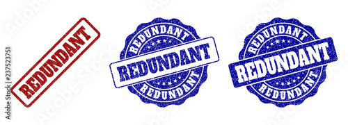 REDUNDANT grunge stamp seals in red and blue colors. Vector REDUNDANT signs with grunge style. Graphic elements are rounded rectangles, rosettes, circles and text titles.