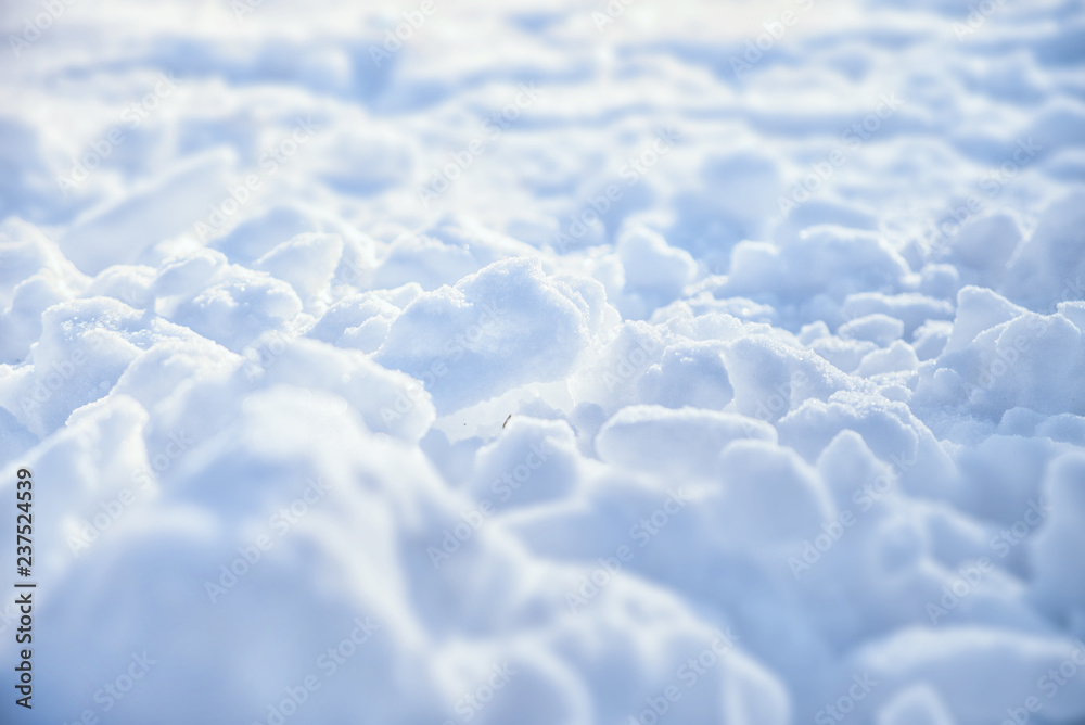 Obraz premium Beautiful Christmas natural image. Snowdrifts of snow in the morning light in the cold outdoors, selective focus. Winter landscape, snow background, texture.