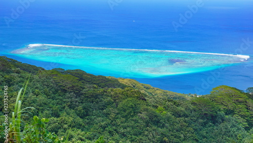 Blue tropical lagoon and green forest seen from the heights of Huahine island in French Polynesia, south Pacific ocean