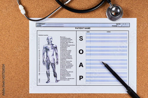 Patient SOAP note sheet, stethoscope and pen on corkwood background. Flat lay.