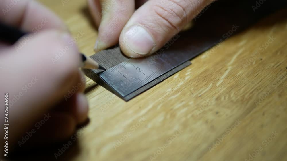 carpenter marks the workpiece from wenge carpenter marks the workpiece from wenge