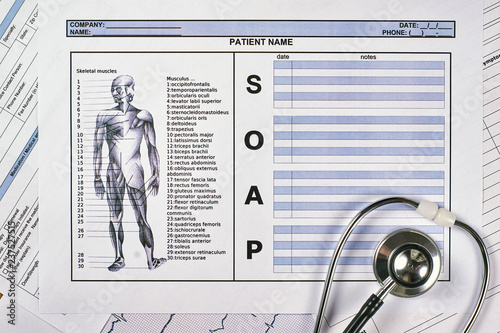 Patient SOAP note sheet, stethoscope on light background. Flat lay. photo