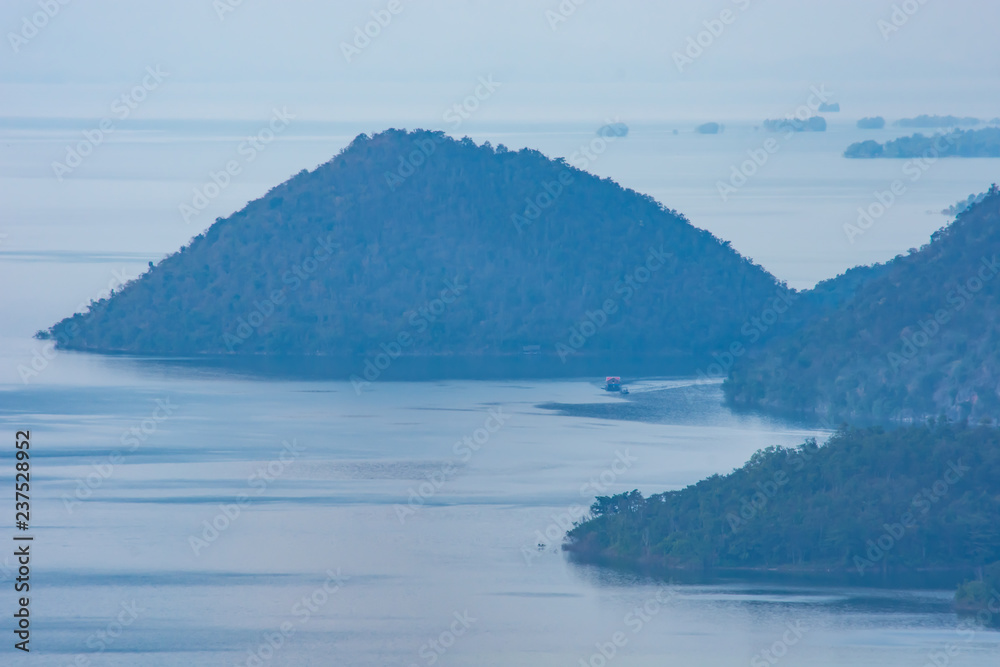 The ships were dragging a houseboat in the dam at Sri Nakarin dam , Kanchana buri in Thailand.
