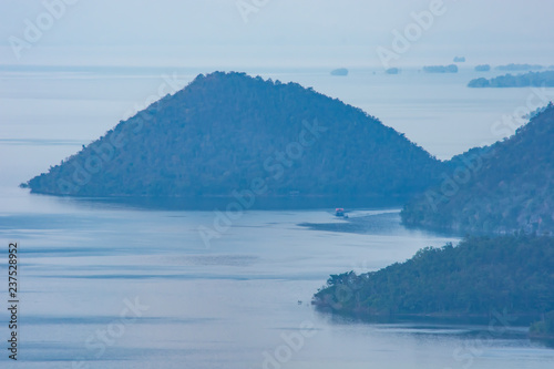 The ships were dragging a houseboat in the dam at Sri Nakarin dam , Kanchana buri in Thailand.