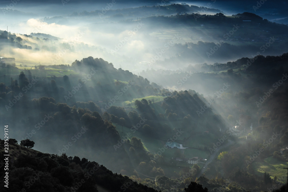 Rays of Sun in the mist of dawn in Karrantza -Bizkaia Rays of Sun in the mist of dawn in Karrantza -Bizkaia