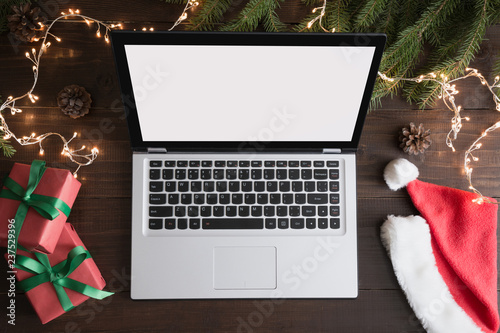 Screen laptop with space for text or special Christmas offer. Xmas shopping by laptop. Top view, flat lay. Holiday concept