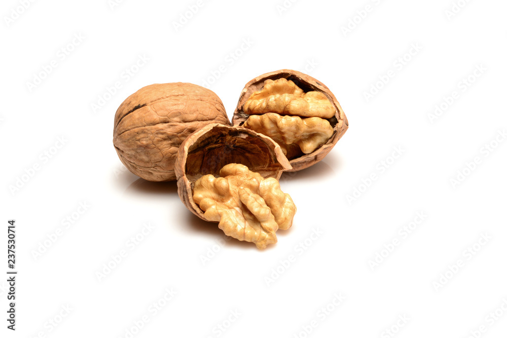 Walnut and kernels, whole walnut and kernels, close-up macro, isolated on a white background. Walnut and kernels, whole walnut and kernels, close-up macro, isolated on a white background.
