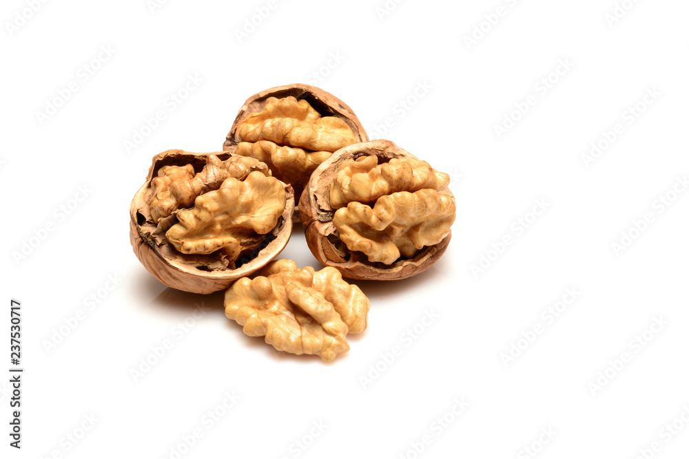 Three open walnuts and kernel, close-up macro, isolated on a white background. Three open walnuts and kernel, close-up macro, isolated on a white background.