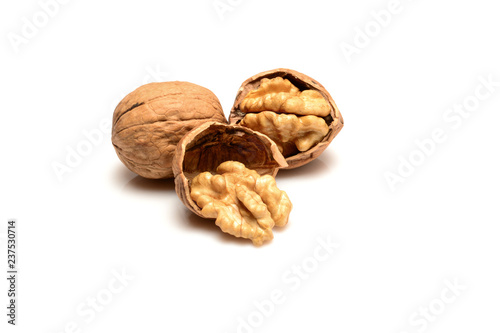 Walnut and kernels, whole walnut and kernels, close-up macro, isolated on a white background.