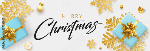 Merry Christmas banner with blue top view gifts and golden snowflakes.