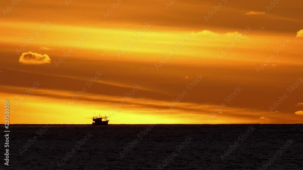 Sunset is a fishing boat running under the sun. Sunset is a fishing boat running under the sun.