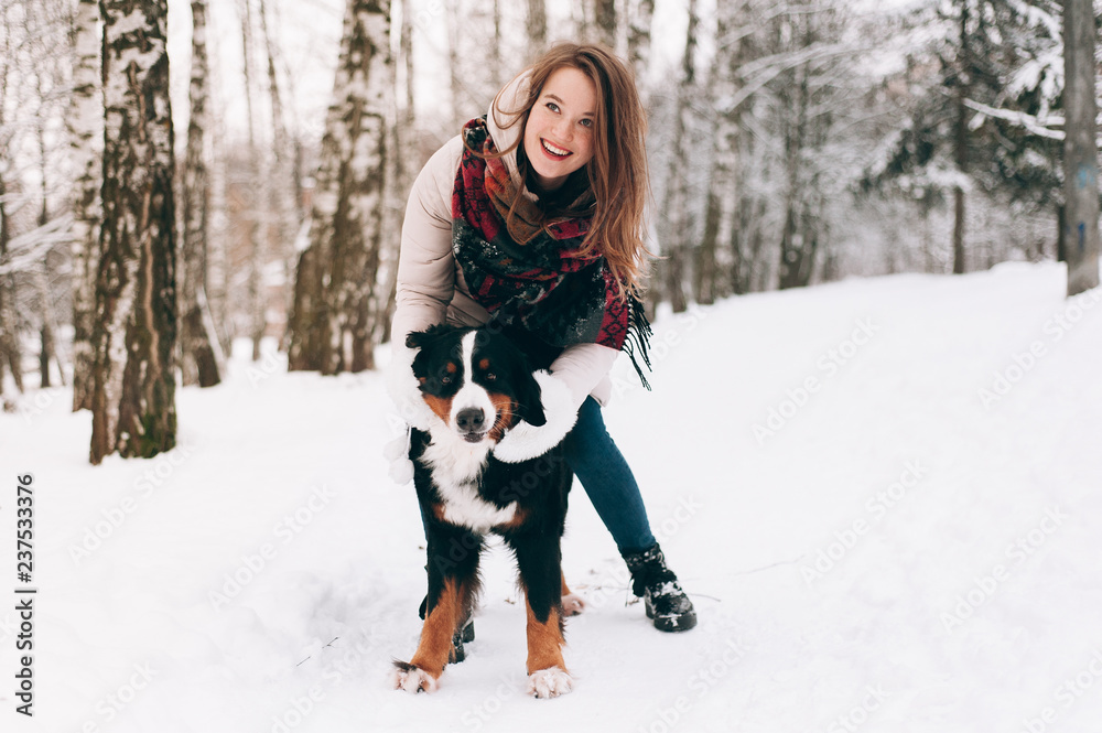 girl with dog in winter forest